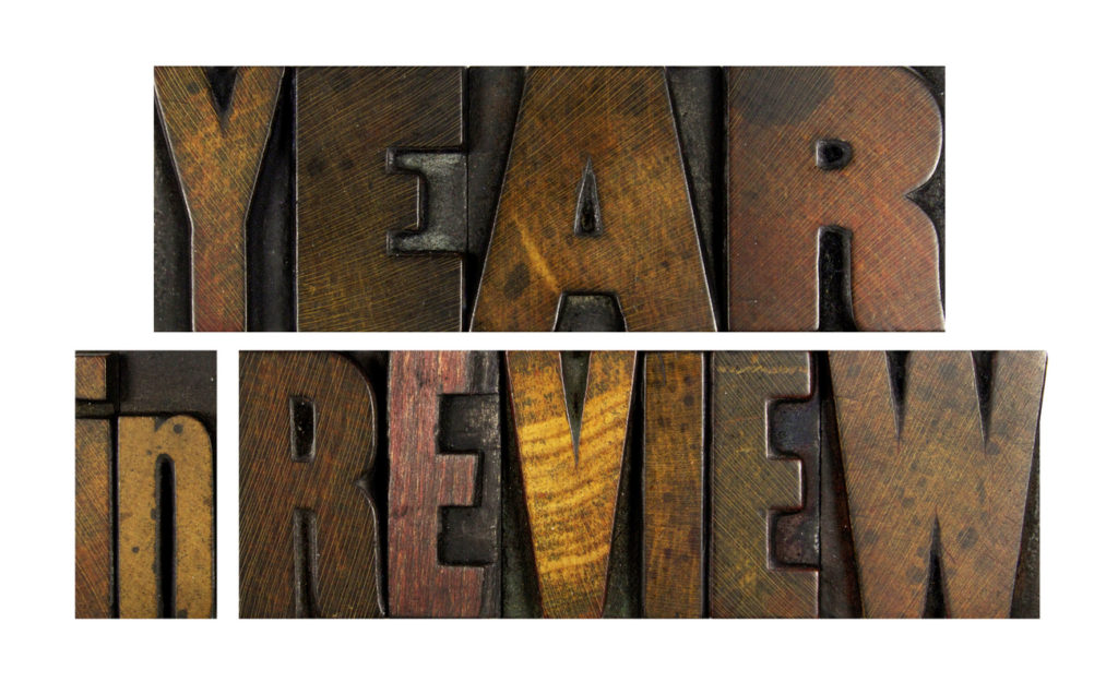 The words YEAR IN REVIEW written in vintage letterpress type